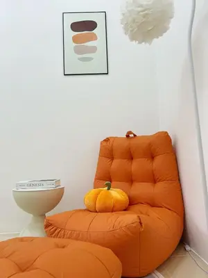 an orange chair with pumpkins on top of it at BM Alma Aeonjusco Auto City Homestay in Bukit Mertajam