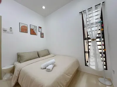 a white bedroom with a bed and a window at BM Alma Aeonjusco Auto City Homestay in Bukit Mertajam