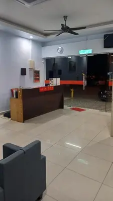 a living room with a ceiling fan and a lobby at JJ Hotel Sitiawan Perak in Sitiawan