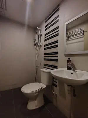 a bathroom with a toilet and a sink at JJ Hotel Sitiawan Perak in Sitiawan