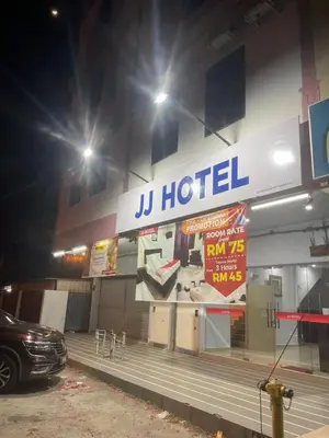 a hotel with a car parked outside at night at JJ Hotel Sitiawan Perak in Sitiawan