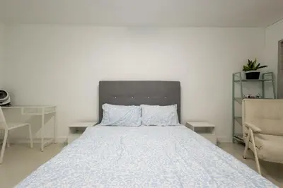 a bedroom with a bed with a gray headboard at Casa Celia - Pet allowed private parking studio in Ipoh