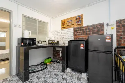 a kitchen with a counter and two refrigerators at Casa Celia - Pet allowed private parking studio in Ipoh