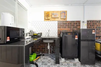 a kitchen with a counter with a microwave and a refrigerator at Casa Celia - Pet allowed private parking studio in Ipoh