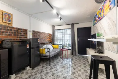 a room with a living room with a couch and a table at Casa Celia - Pet allowed private parking studio in Ipoh