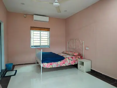a bedroom with a bed with a blue blanket at Homestay Teratak Atas Bukit