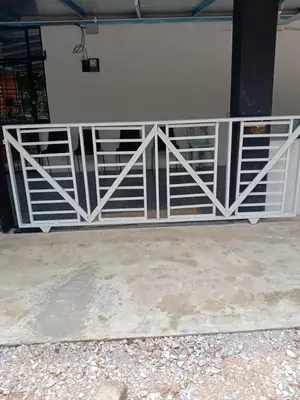 a gate on the side of a building at Homestay Teratak Atas Bukit