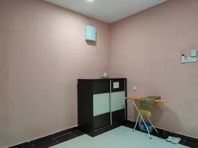 a room with a black refrigerator and a chair at Homestay Teratak Atas Bukit