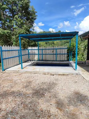 a blue bus stop with a blue canopy at Homestay Teratak Atas Bukit