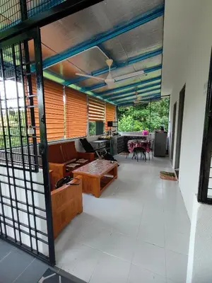 a living room with a couch and a table at Homestay Teratak Atas Bukit