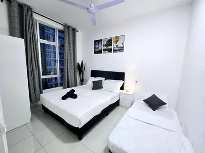 two beds in a white room with a window at b04 The Anderson Ipoh Family Stay 2BR in Ipoh
