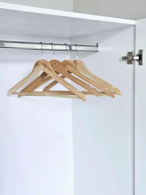 a pair of wooden hangers hanging from a door at c02 The Anderson Ipoh Family Stay 2BR in Ipoh