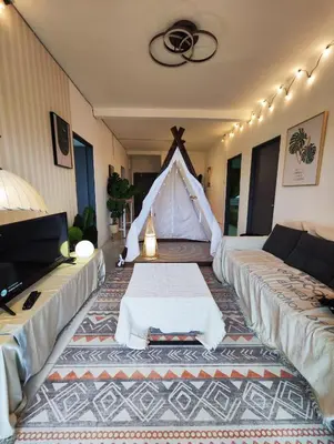 a living room with a couch and a tent at Cameron Highland 915 Glamping Style 3BR 10 Pax in Brinchang