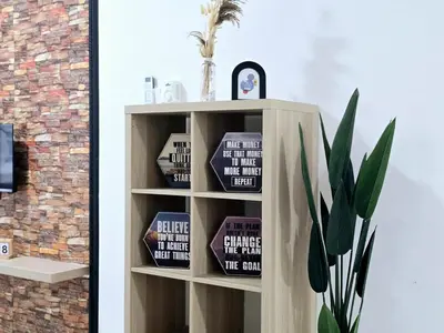 a book shelf with books on it next to a plant at c04 The Anderson Ipoh Family Stay 2BR in Ipoh