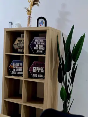 a book shelf with pillows and a plant at c04 The Anderson Ipoh Family Stay 2BR in Ipoh
