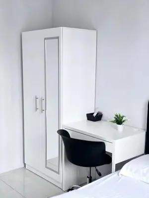 a bedroom with a mirror and a desk with a chair at c04 The Anderson Ipoh Family Stay 2BR in Ipoh