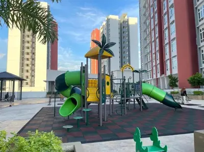 a playground with green and yellow slides in a city at a06 The Anderson Ipoh Family Stay 2BR in Ipoh