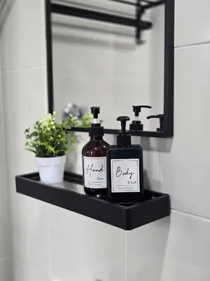 a bathroom shelf with two bottles of soap and a mirror at d01 The Anderson Ipoh Family Stay 2BR in Ipoh
