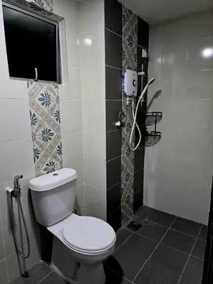 a bathroom with a toilet and a tv on the wall at d01 The Anderson Ipoh Family Stay 2BR in Ipoh