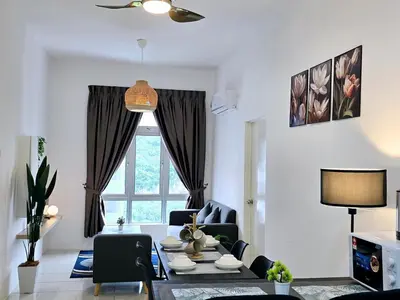 a living room with a table and chairs and a window at d02 The Anderson Ipoh Family Stay 2BR in Ipoh