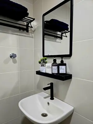 a bathroom with a sink and a mirror at d02 The Anderson Ipoh Family Stay 2BR in Ipoh