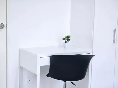 a black chair sitting next to a white desk at d02 The Anderson Ipoh Family Stay 2BR in Ipoh