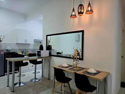 a kitchen with a table and chairs and a mirror at b03 The Anderson Ipoh Family Stay 2BR in Ipoh