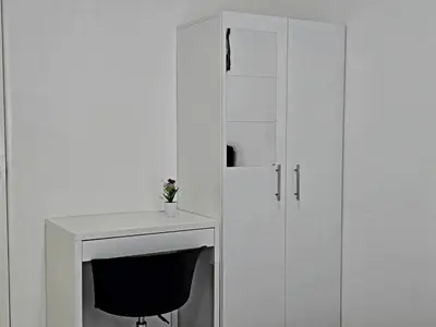 a white desk with a chair next to a cabinet at a04 The Anderson Ipoh Family Stay 2BR in Ipoh