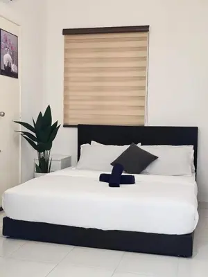 a large white bed with a blue ribbon on it at b02 The Anderson Ipoh Family Stay 2BR in Ipoh