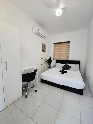 a bedroom with a bed and a desk and a computer at b02 The Anderson Ipoh Family Stay 2BR in Ipoh