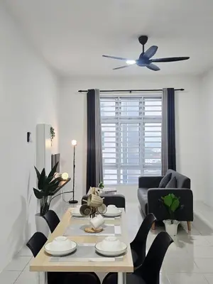 a living room with a table and a ceiling fan at d09 The Anderson Ipoh Family Stay 2BR in Ipoh