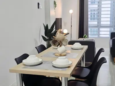 a dining room table with chairs and a lamp on it at d09 The Anderson Ipoh Family Stay 2BR in Ipoh
