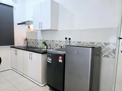 a kitchen with white cabinets and a refrigerator at d09 The Anderson Ipoh Family Stay 2BR in Ipoh