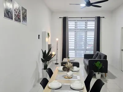 a living room with a table and a ceiling fan at d09 The Anderson Ipoh Family Stay 2BR in Ipoh