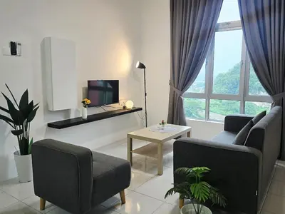 a living room with a couch and a tv at d15 The Anderson Ipoh Family Stay 2BR in Ipoh