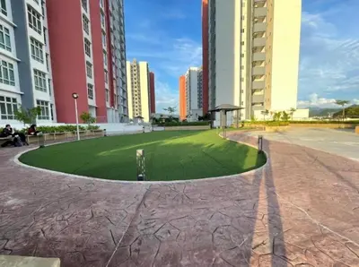 a grassy area in a city with tall buildings at b05 The Anderson Ipoh Family Stay 2BR in Ipoh