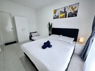 a bedroom with a white bed with a blue object on it at b05 The Anderson Ipoh Family Stay 2BR in Ipoh