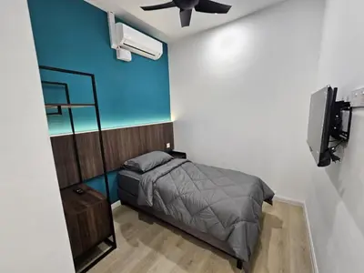 a bedroom with a bed and a ceiling fan at Roomstay KOBANAS in Ipoh