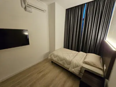 a small bedroom with a bed and a window at Roomstay KOBANAS in Ipoh