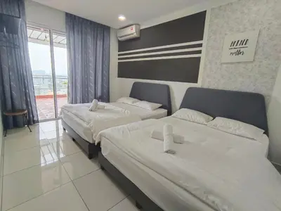 two beds in a hotel room with white sheets at Jomstay Octagon Ipoh Penthouse in Ipoh