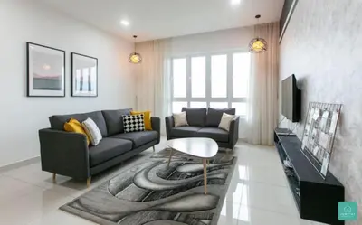 a living room with a couch and a table at Jomstay Octagon Ipoh Penthouse in Ipoh