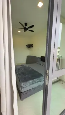 a bedroom with a bed with a ceiling fan at Ether 665 Homestay in Sekincan