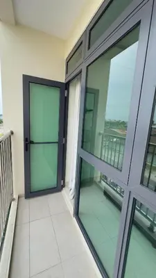 a balcony with glass doors on a building at Ether 665 Homestay in Sekincan