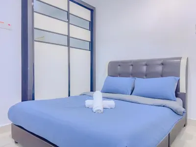 a bed with a white teddy bear sitting on it at 2BR SeaView Retreat At Mansion1 in George Town