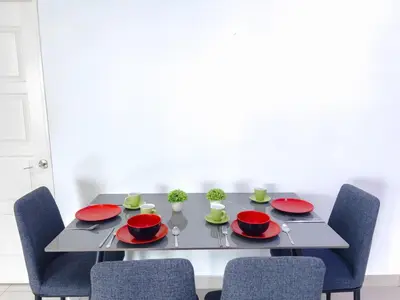 a dining room table with red plates and chairs at 2BR SeaView Retreat At Mansion1 in George Town