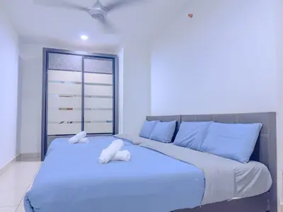 a bedroom with a large bed with blue pillows at 2BR SeaView Retreat At Mansion1 in George Town