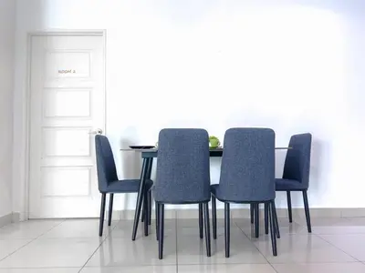 a dining room table with four blue chairs at 2BR SeaView Retreat At Mansion1 in George Town