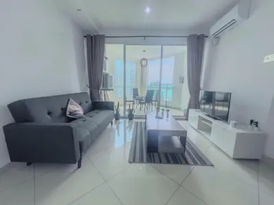 a living room with a couch and a table at 2BR SeaView Retreat At Mansion1 in George Town