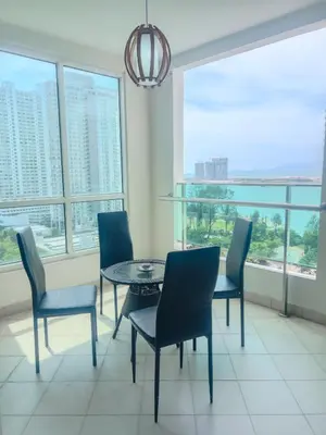 a dining room with a table and chairs and windows at 2BR SeaView Retreat At Mansion1 in George Town