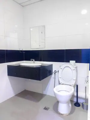 a bathroom with a toilet and a sink at 2BR SeaView Retreat At Mansion1 in George Town